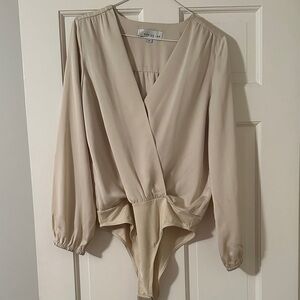 Adelyn Rae Cream Long Sleeve Bodysuit